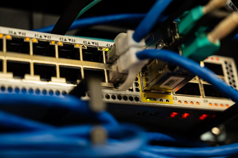 Ethernet cables connected to a network switch with status lights